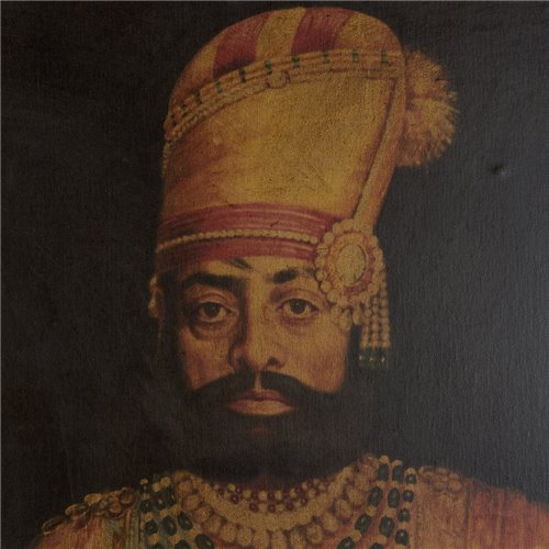 Portrait of Maharaja Takhat Singh sitting with sculpted wooden frame